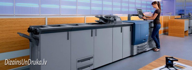 Woman operating a modern printing machine for prompt digital printing