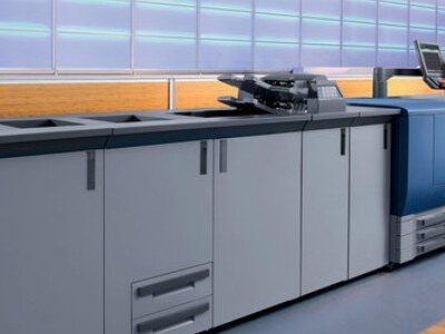 Sieviete pie modernas poligrāfijas iekārtas operatīvai drukai