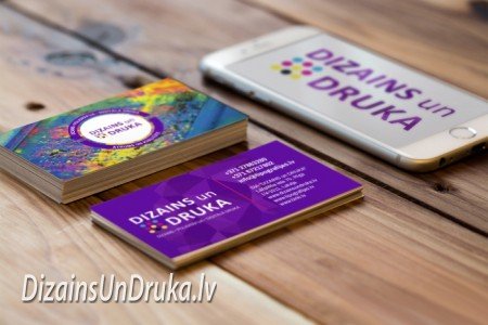 Business cards and a smartphone on a wooden table